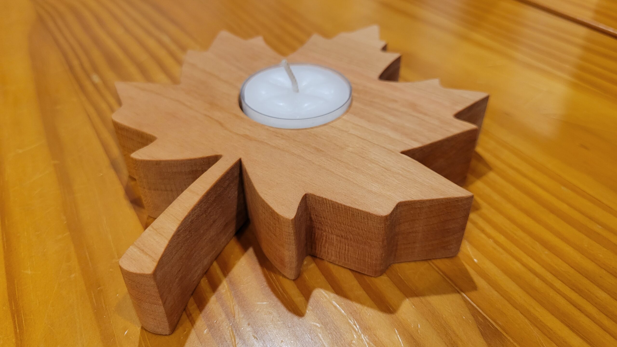 wood maple leaf with tealight candle set in the middle