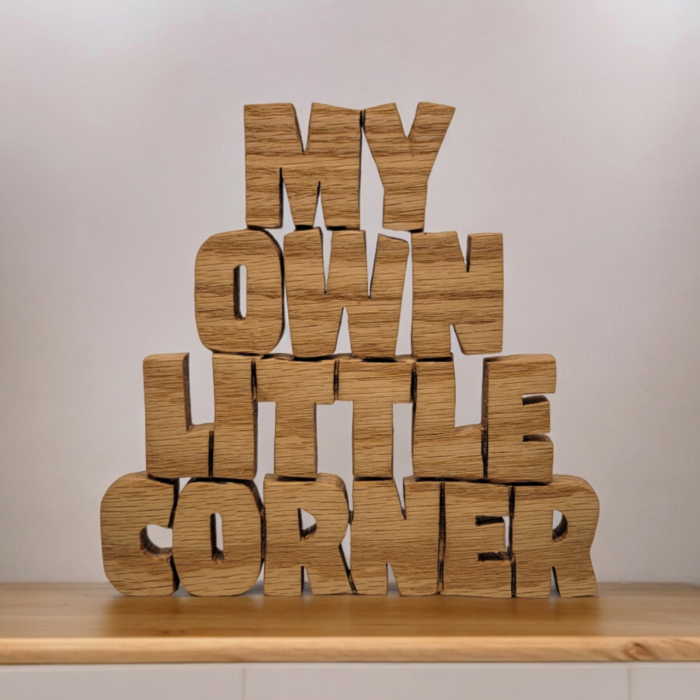 Wood plaque cut from a single piece of wood that reads "My Own Little Corner".