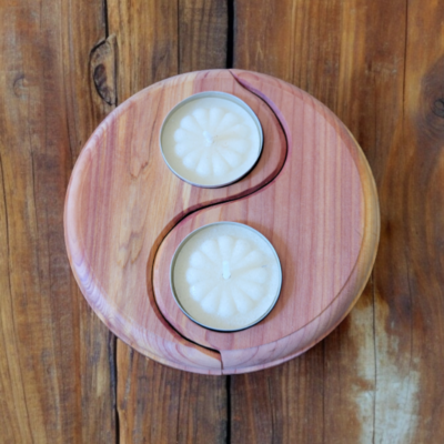 A two piece candle holder shaped in the Yin Yang symbol, crafted from beautiful cedar, holding two tealight candles