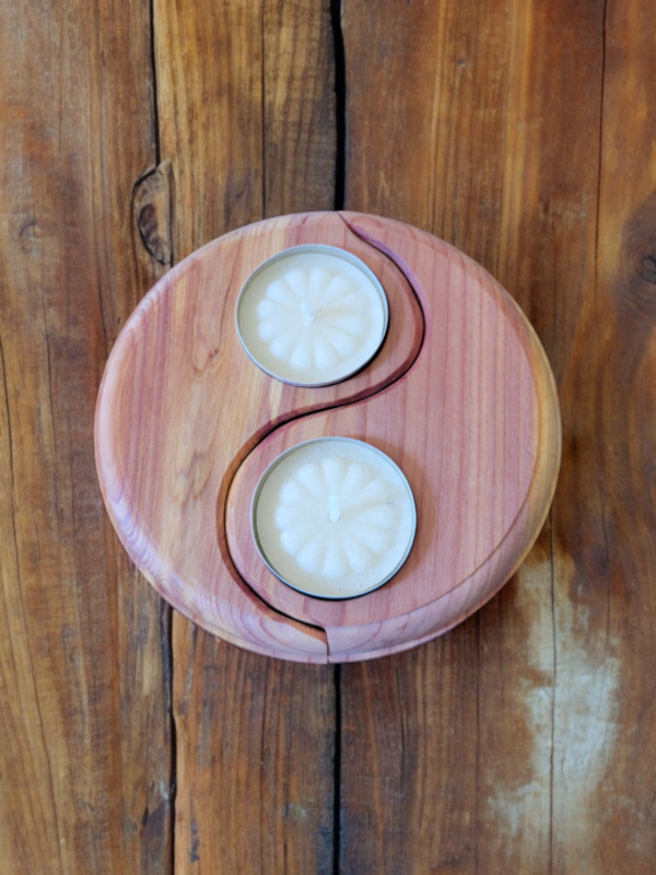 A two piece candle holder shaped in the Yin Yang symbol, crafted from beautiful cedar, holding two tealight candles