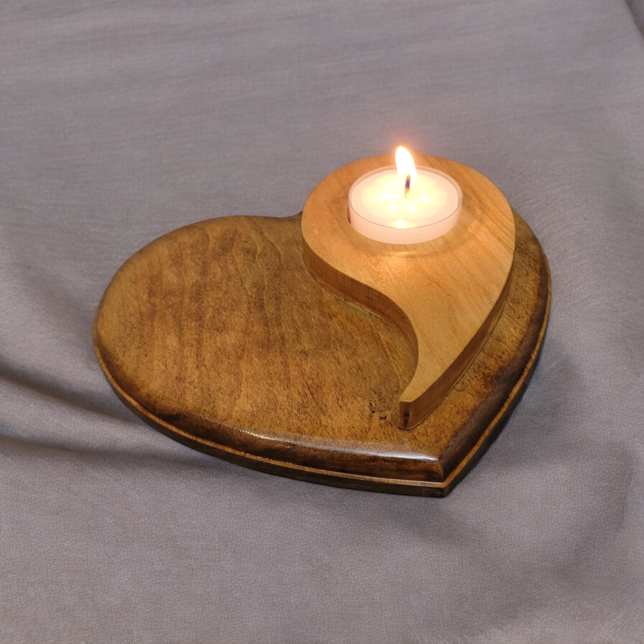 Natural wood tealight holder, in the shape of a heart with the yin yang symbol on top.