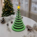 Ornamental wood christmas tree made from wood discs, decreasing in size up to the top. A yellow star adorns the tree.