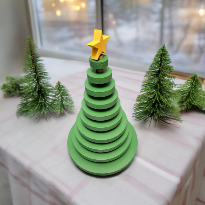 Ornamental wood christmas tree made from wood discs, decreasing in size up to the top. A yellow star adorns the tree.