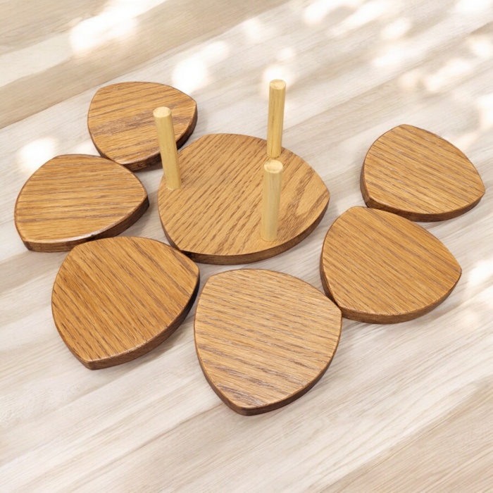 Six solid oak coasters with a holder sitting on a table top.