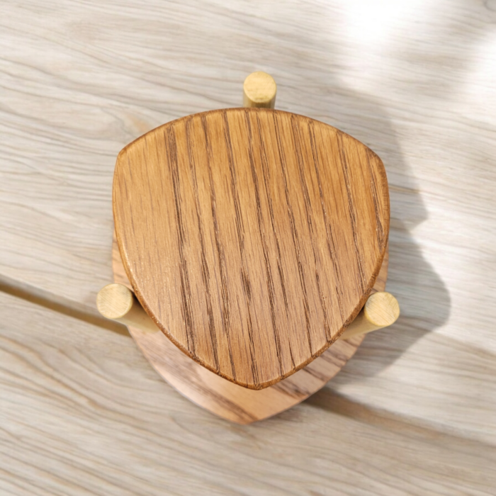 Six solid oak coasters with a holder sitting on a table top.