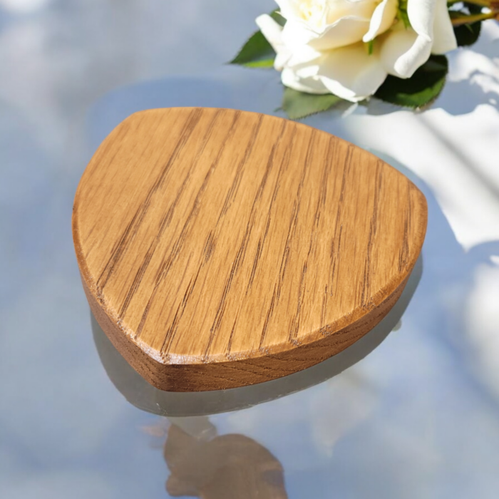 Six solid oak coasters with a holder sitting on a table top.