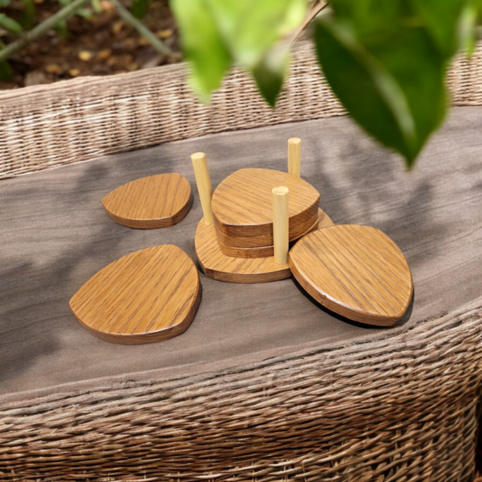 Six solid oak coasters with a holder sitting on a table top.