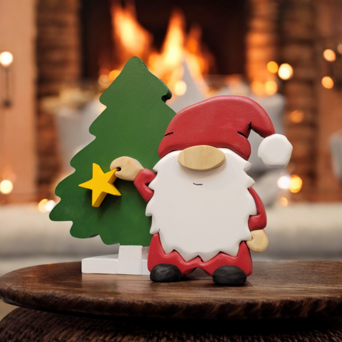 Christmas gnome with while beard, red hat, holding a yellow star, standing in front of a tall green tree.