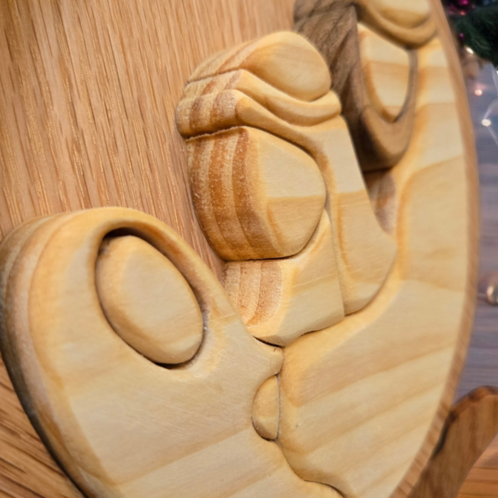 The Holy Family together at the base of the teardrop shaped plaque.