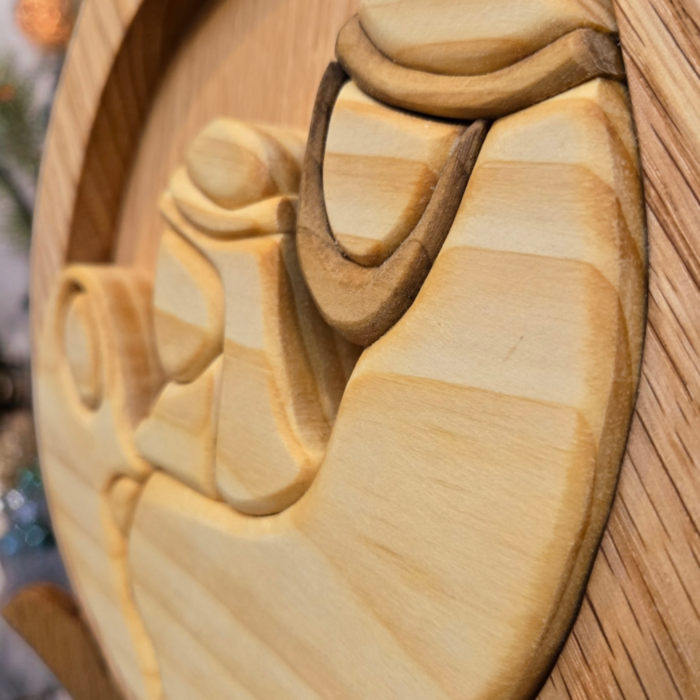 The Holy Family together at the base of the teardrop shaped plaque.