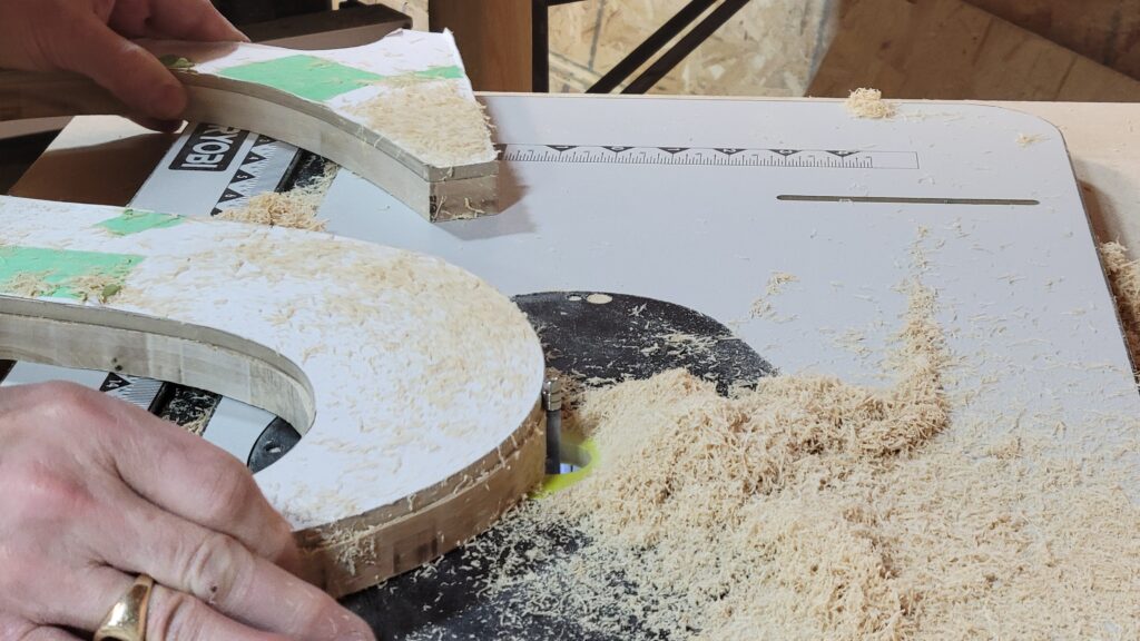 Photo of a large letter S being cut out using a table router.