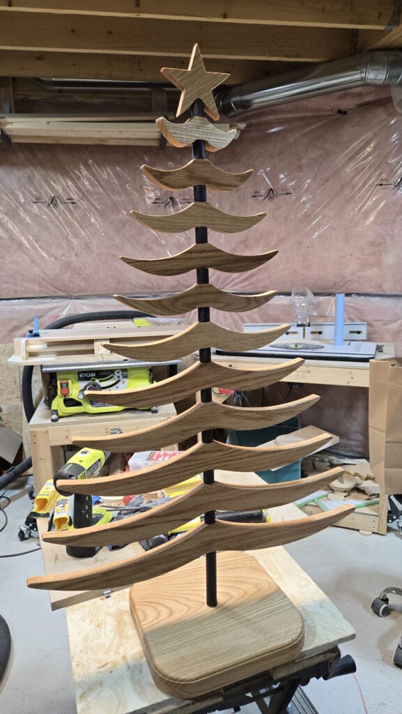 Wooden Christmas tree standing on a workbench in the workshop.