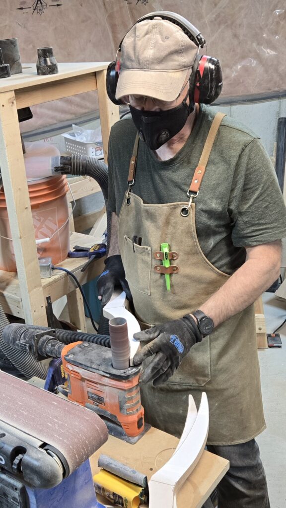 Maker in shop, shaping the branches for the Tannenbaum tree.